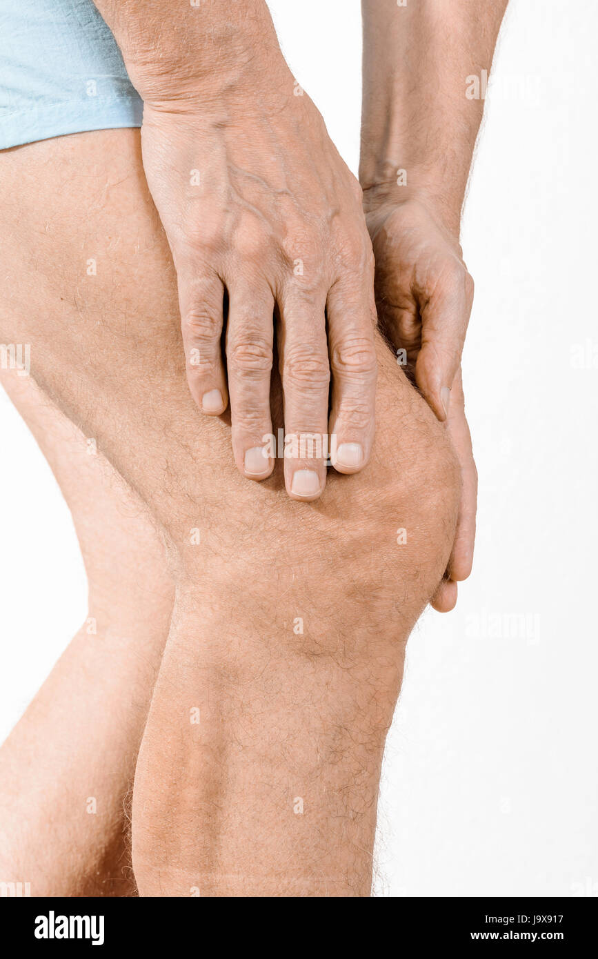 Massage homme sportif un quadriceps douloureux et le genou après un accident de sport. Il pourrait s'agir d'un quadriceps tendinopathie, une élongation musculaire, un Banque D'Images