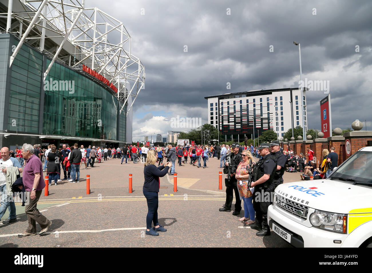 Fans de poser pour des photos avec des policiers sur l'obligation avant le témoignage de Michael Carrick match à Old Trafford, Manchester. Banque D'Images