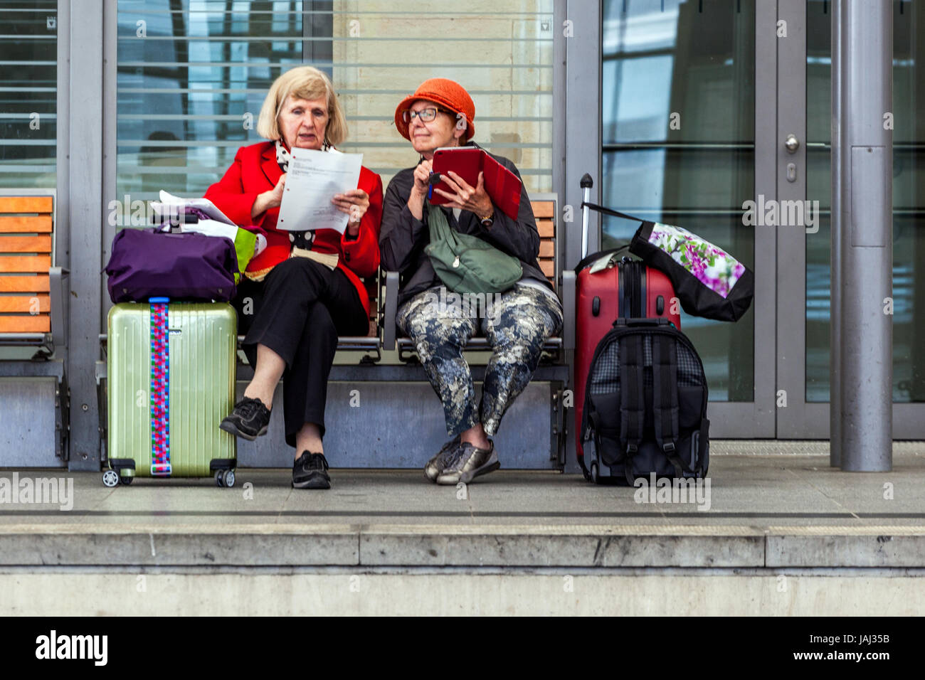 Deux femmes âgées avec des valises assis sur le banc et en attente d'un train, Hauptbahnhof, Dresde, Saxe, Allemagne Banque D'Images