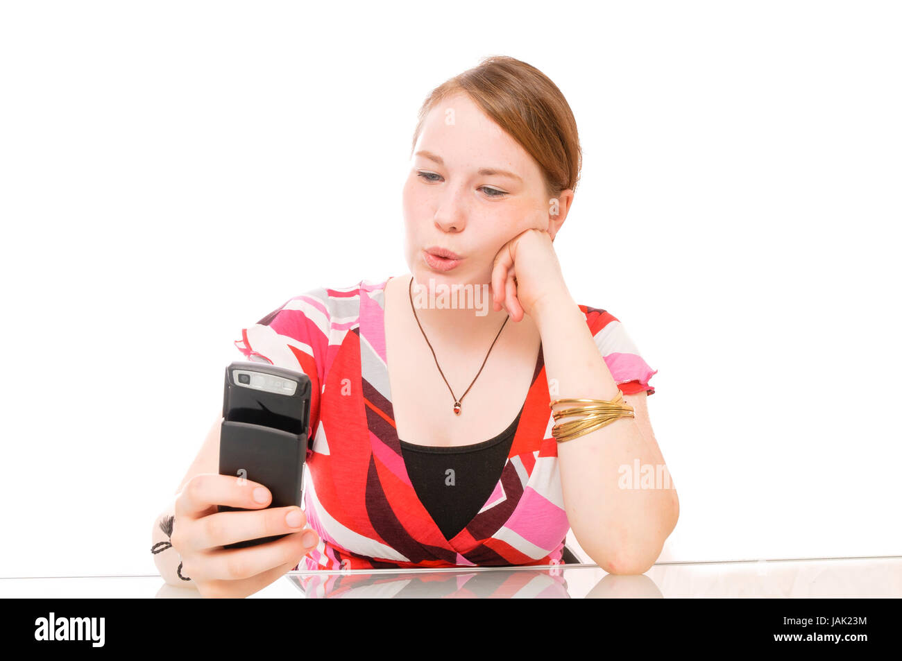 Teenager-Mädchen telefoniert Mobiltelefon mit weißem vor Hintergrund. Banque D'Images