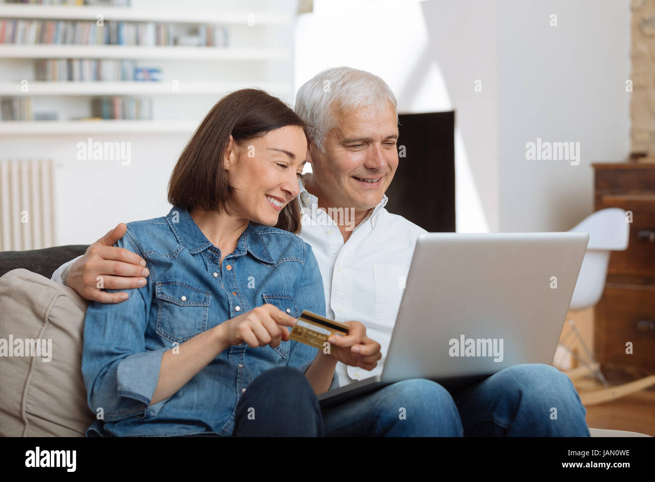 Mature Couple connecté avec un ordinateur portable et des achats en ligne Banque D'Images