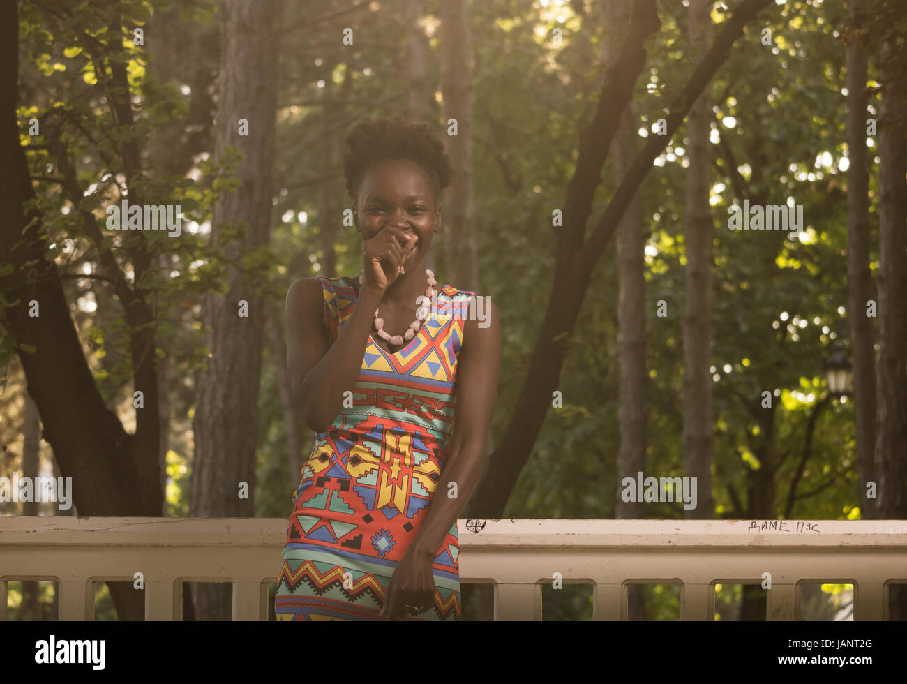 L'un, jeune adulte, black african american happy smiling rire sincère franche femme 20-29 ans, debout, à la recherche d'appareil photo, dehors parc nature, s Banque D'Images