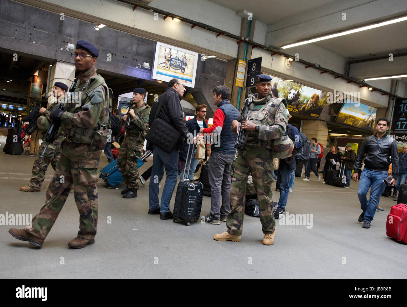 La sécurité militaire française patrouillant à l'arme automatique à la Gare Montparnasse, Paris, France Banque D'Images