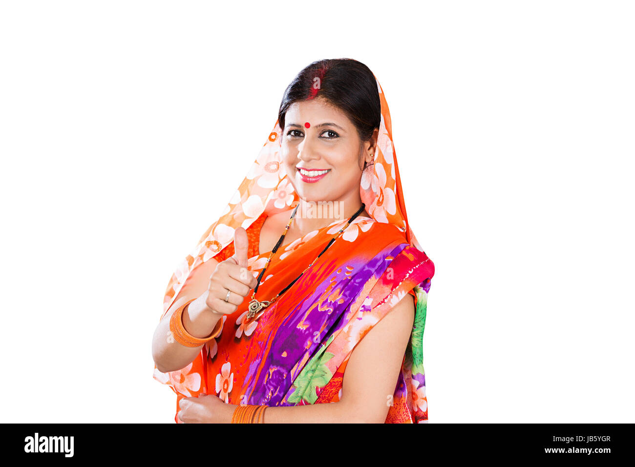 1 femme femme au foyer rural indien et permanent Showing Thumbs up succès Smiling Banque D'Images