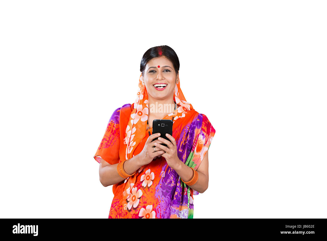 Happy 1 Rural Indien Woman Reading Text Message On Mobile Phone on white background Banque D'Images