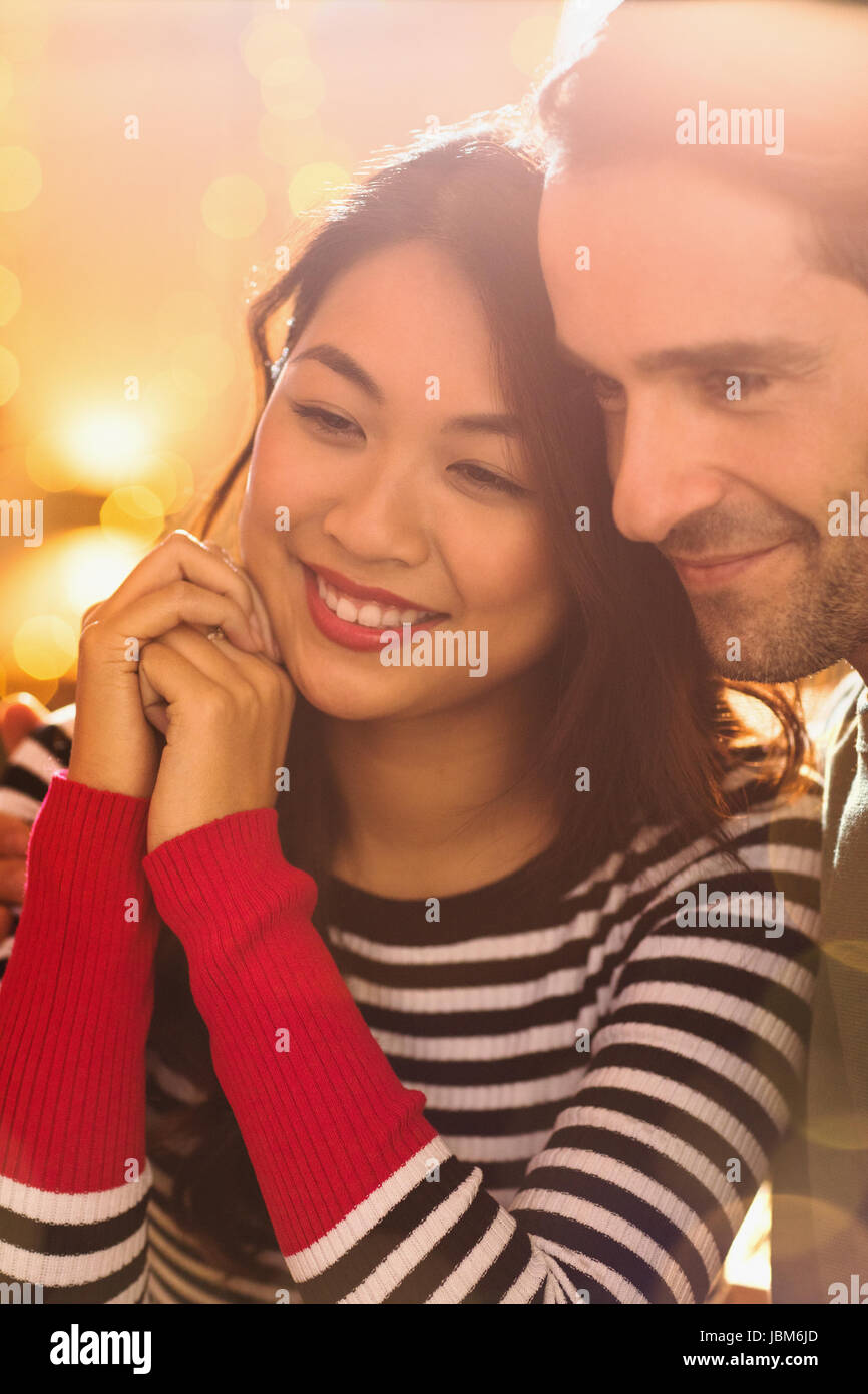 Close up smiling, affectionate couple looking away Banque D'Images