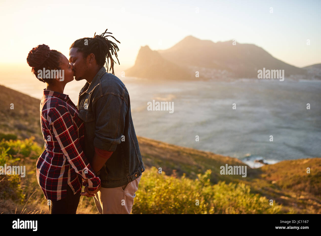 Couple d'origine africaine s'embrasser en plein air dans un magnifique paysage Banque D'Images