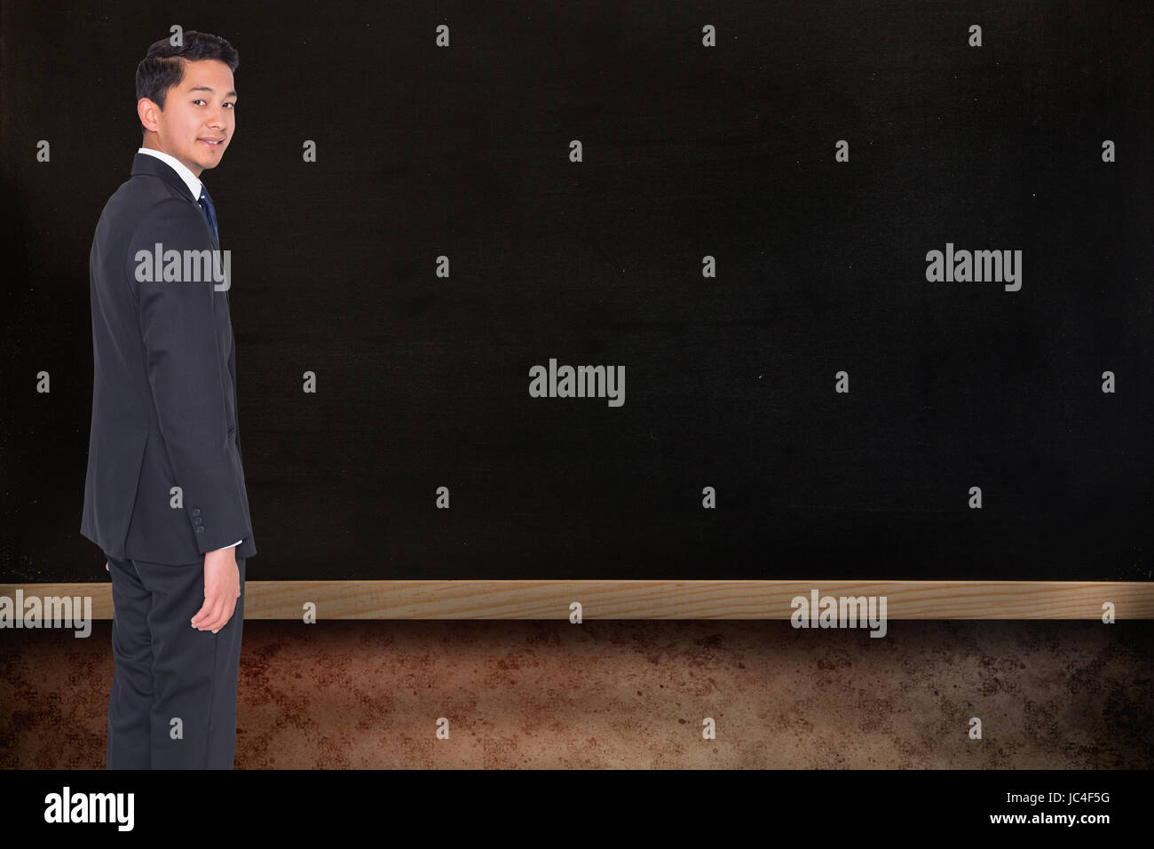 Composite image of businessman looking at camera Banque D'Images