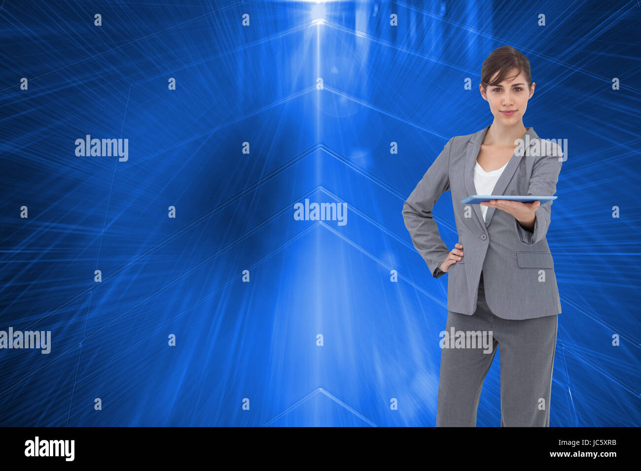 Image composite de l'attractive businesswoman holding tablet pc Banque D'Images