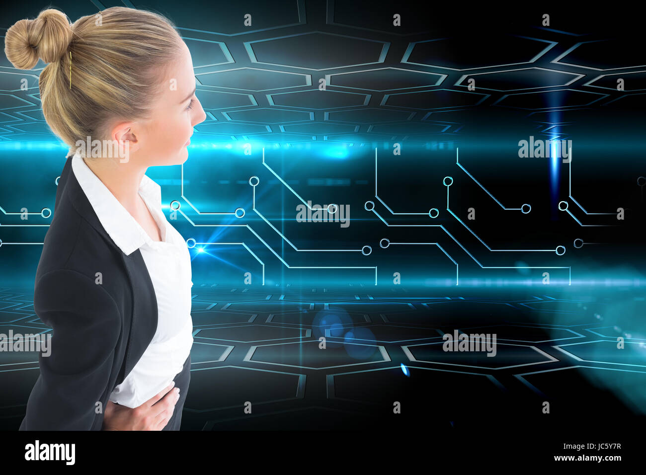 Image composite de blond businesswoman standing with hands on hips Banque D'Images