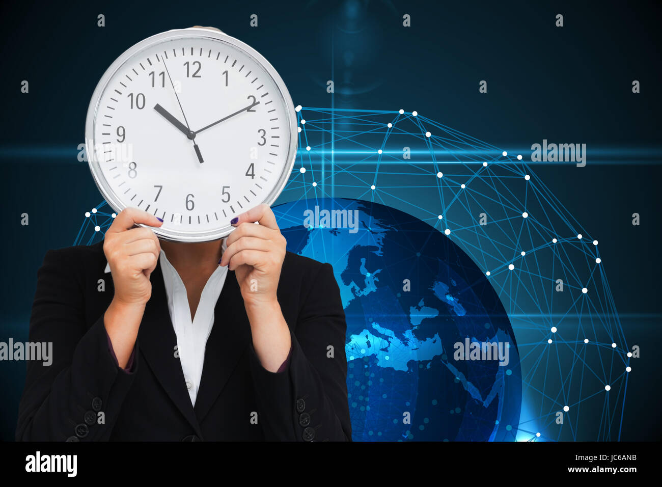 Composite image of businesswoman in suit holding a clock Banque D'Images