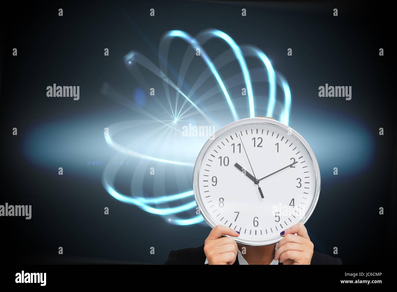 Composite image of businesswoman in suit holding a clock Banque D'Images