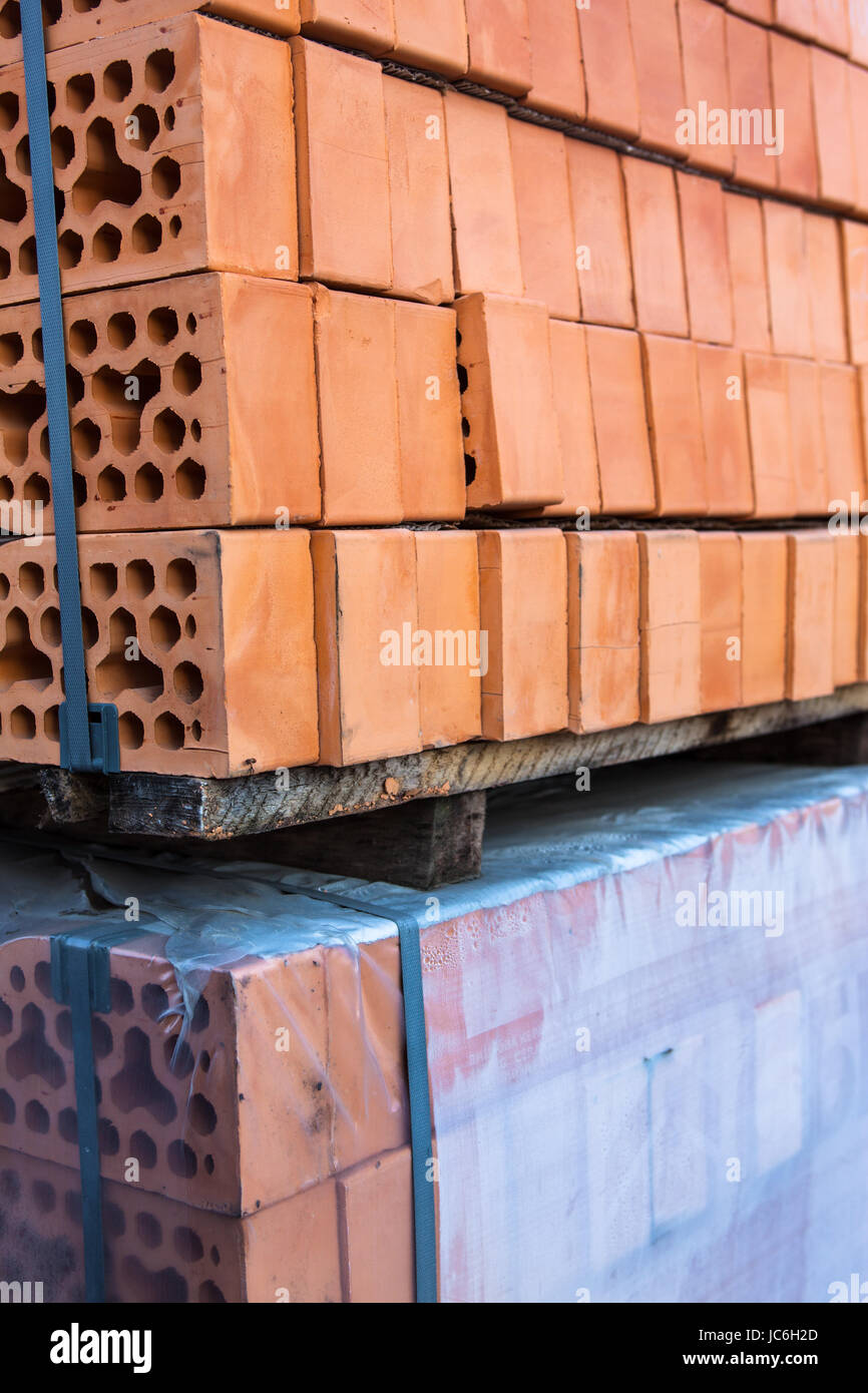 Des piles de briques de silicate sur des palettes en bois et dans le polyéthylène Banque D'Images