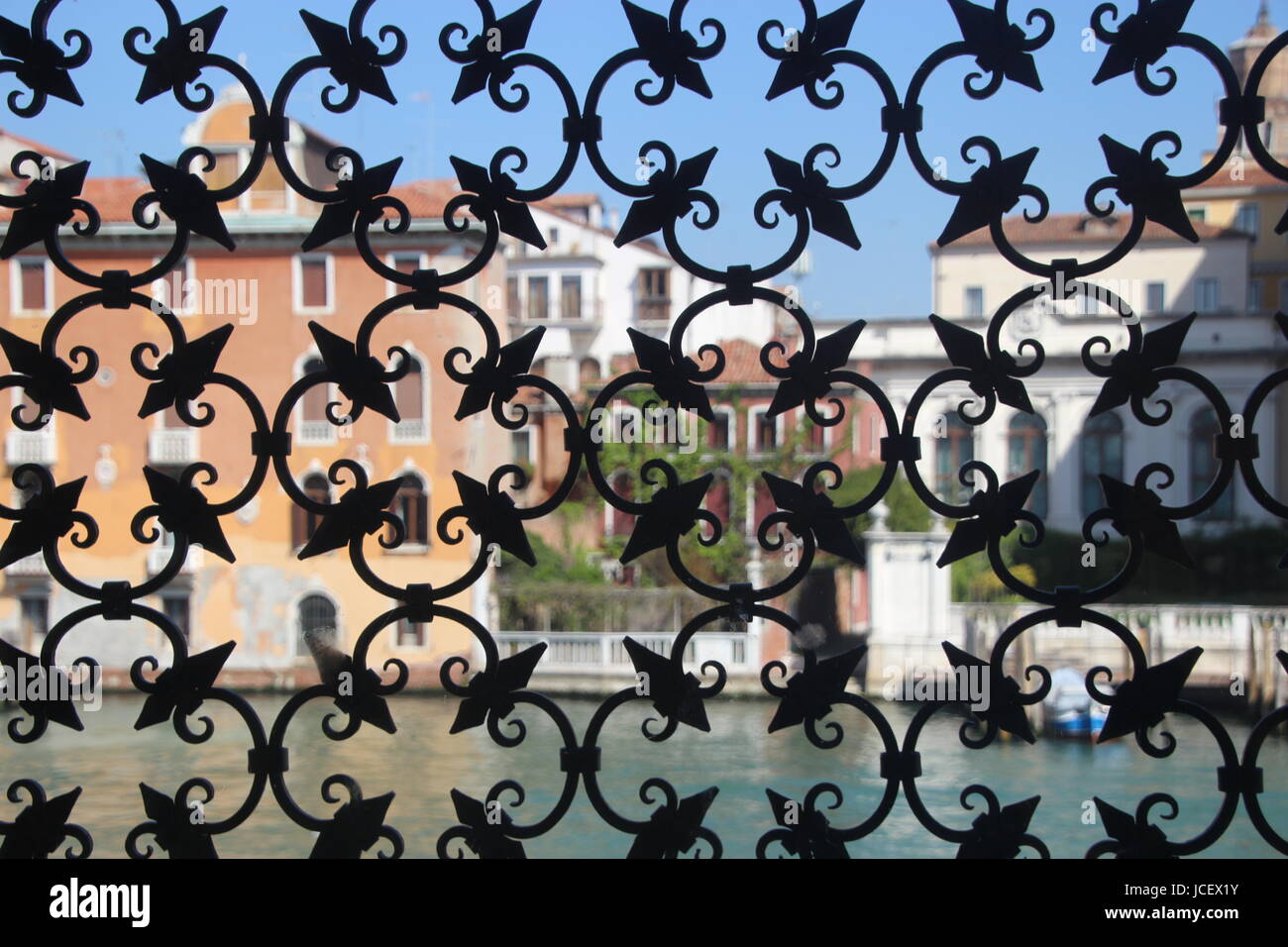 Le Grand Canal à Venise, vue à travers une grille de fenêtre en fer forgé d'un palazzo. Venise, Italie, Europe. Banque D'Images