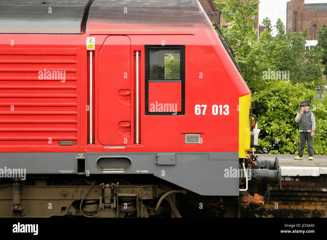 Petit garçon debout à côté de la locomotive diesel de la classe 67 67013 debout à la gare de New York. Banque D'Images