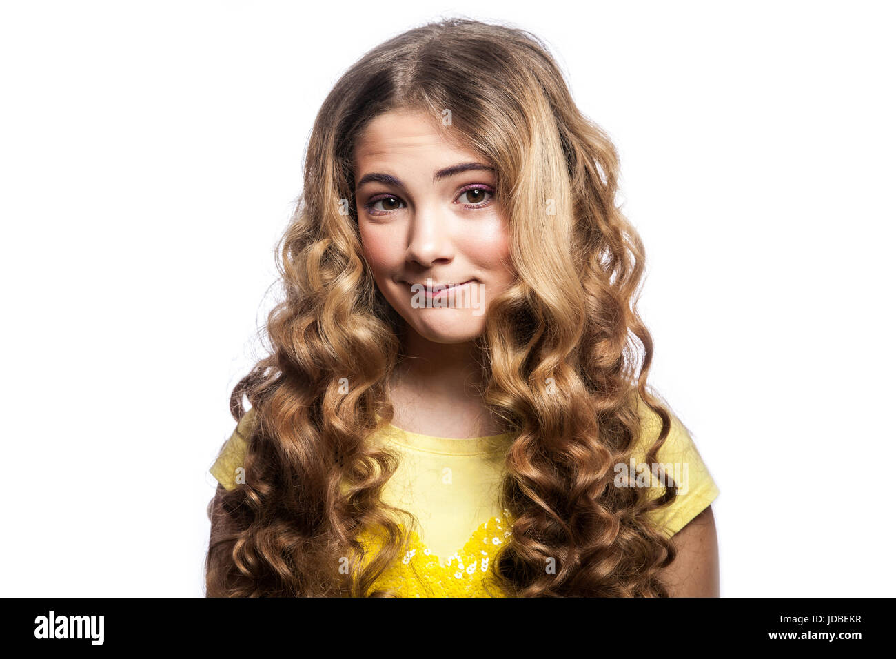 Portrait of happy girl with wavy hairstyle et jaune t shirt. studio shot isolé sur fond blanc. Banque D'Images
