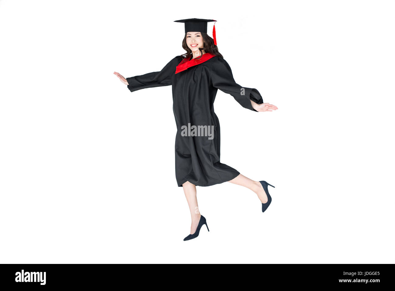 En étudiant attrayant graduation cap avec diplôme jumping isolated on white Banque D'Images