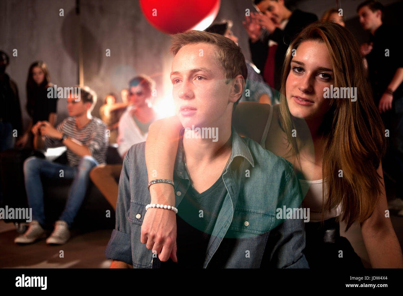 Couple in nightclub adolescente avec bras autour de teenage boy Banque D'Images