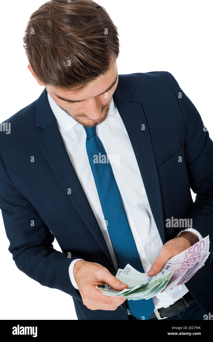 Erfolgreicher jungen Geschäftsmann Wohlhabender mit einer Handvoll von Euro-Banknoten mit einem Lächeln glücklichen zeigt seinen Wohlstand isoliert auf weiß Banque D'Images