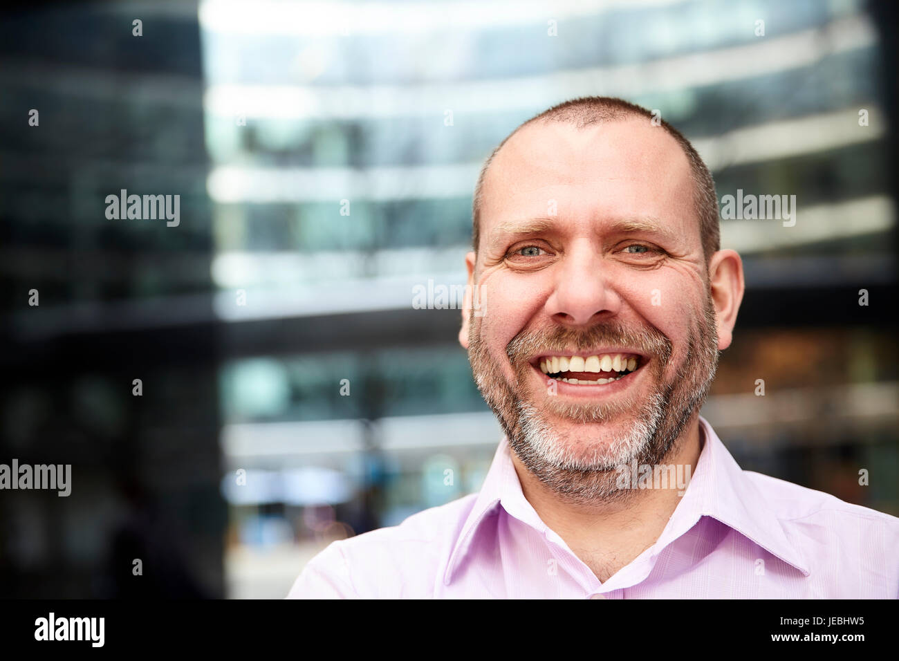 Portrait of Laughing Man en face de son bureau. Banque D'Images