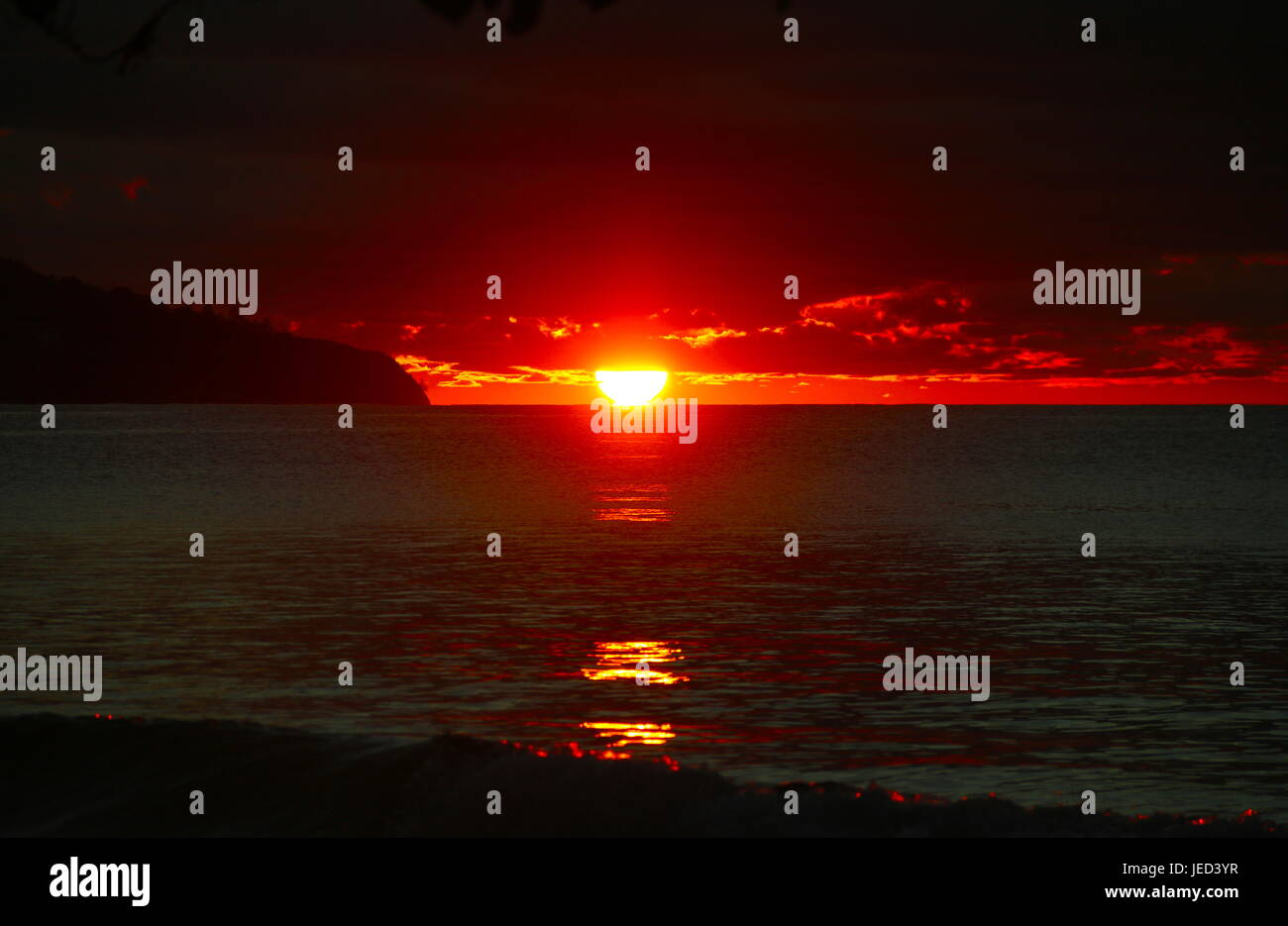 Coucher de soleil rouge rebondit au large de la côte de Mahé. Banque D'Images