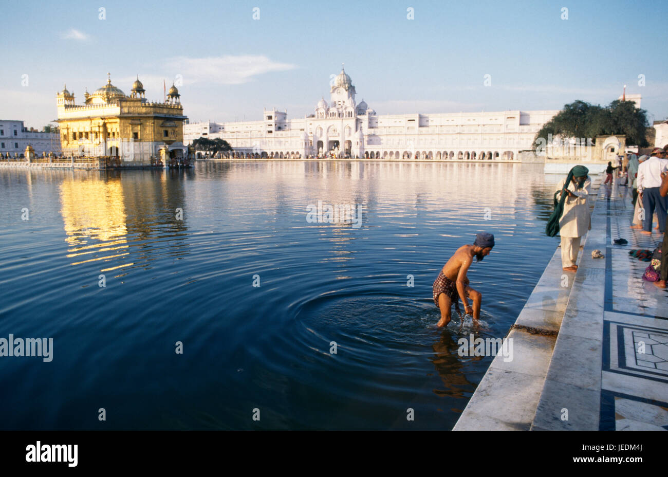 L'Inde, Punjab, Amritsar, l'homme se baigner dans la piscine sacrée du temple d'or complexe. Banque D'Images