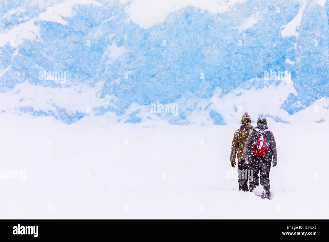 Un couple en raquettes Portage Lake au cours d'une importante chute de neige en hiver pour voir le terminus de Portage Glacier, Southcentral Alaska, USA Banque D'Images