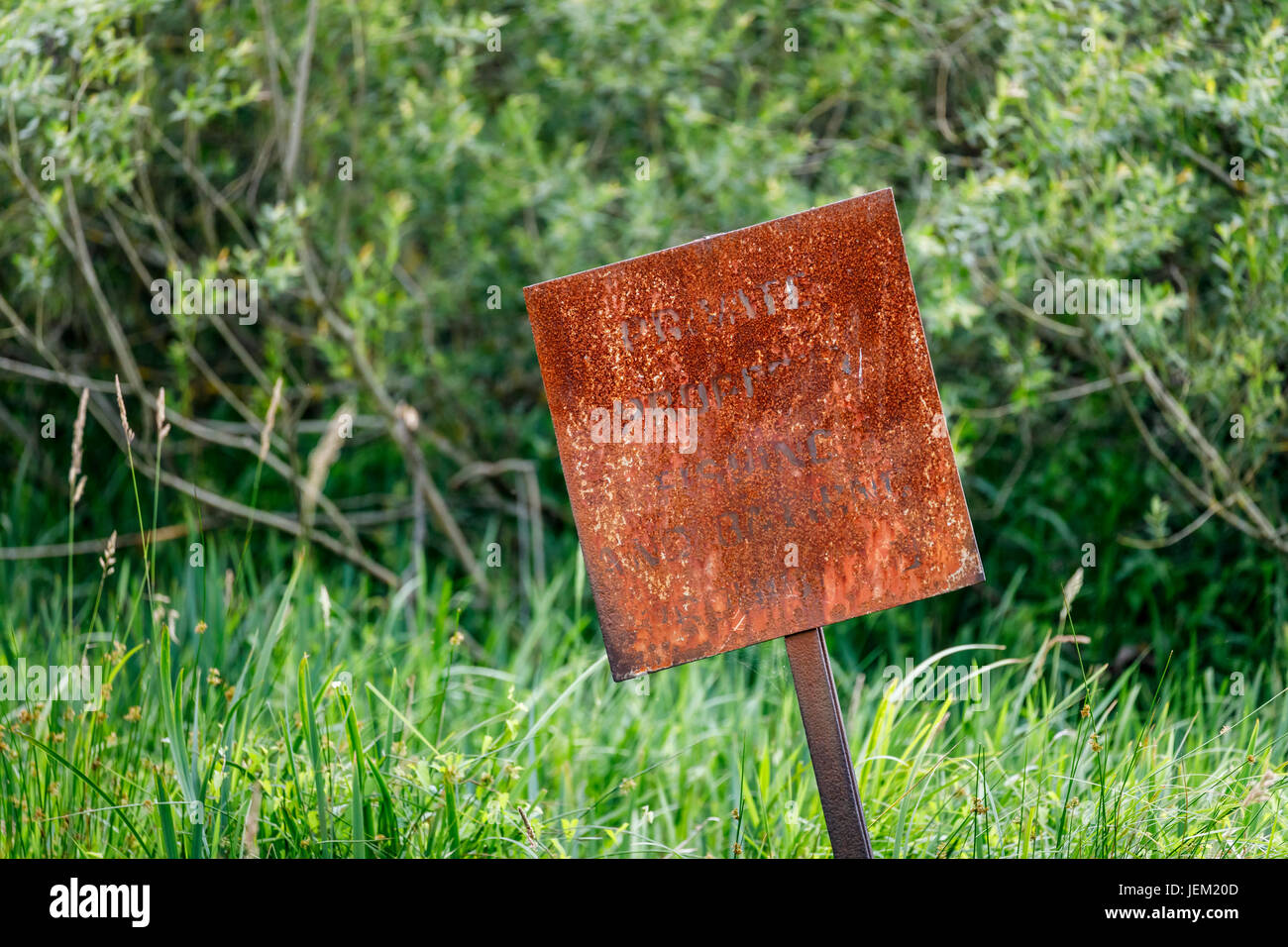 Fortement rouillé presque illisible rusty signe de propriété privée dans la basse vallée d'essai près de la rivière Test, Redbridge, Totton et Ealing, Southampton Banque D'Images