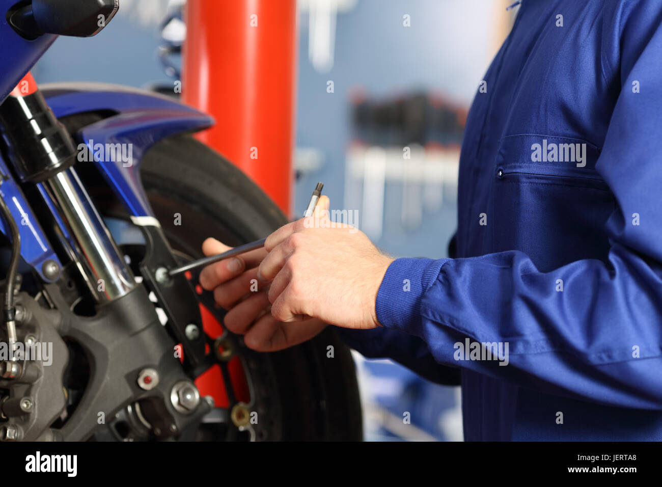 Mécanicien moto mains démontage des pièces dans un atelier avec de  l'équipement à l'arrière-plan Photo Stock - Alamy