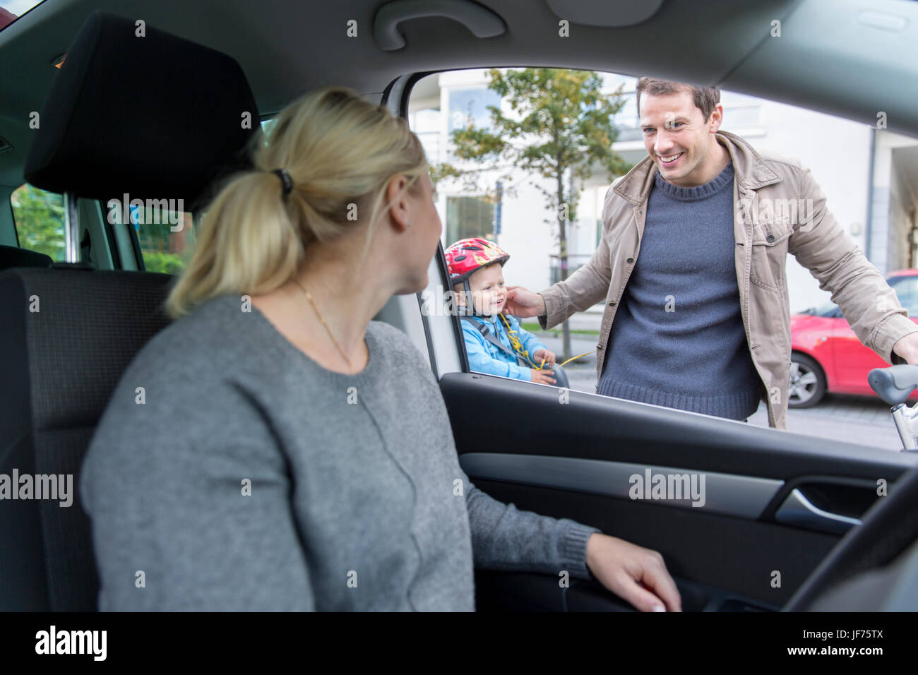 Parler à l'homme femme alors qu'elle est le moteur de voiture Banque D'Images