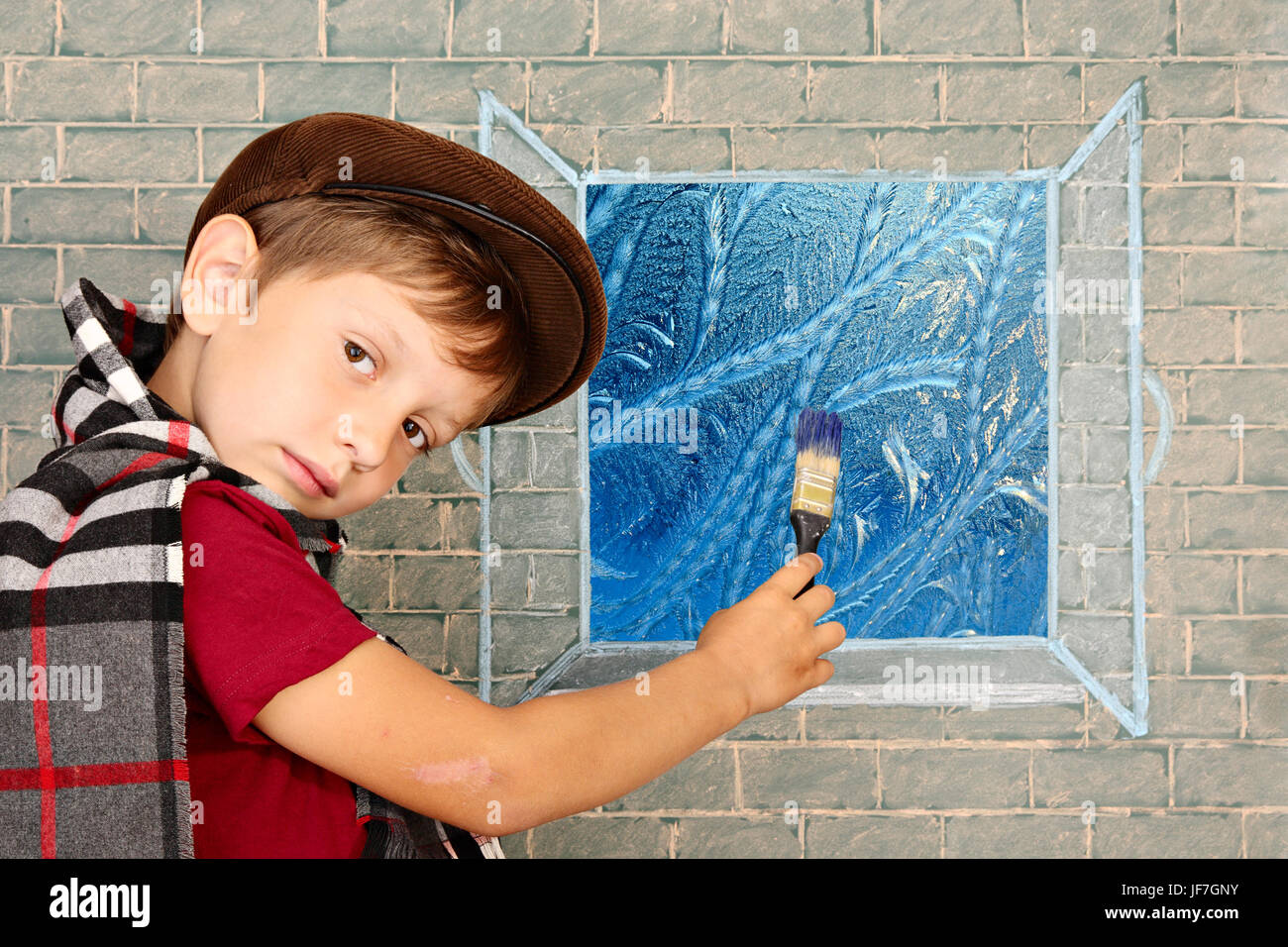 Petit garçon, l'artiste s'appuie sur la fenêtre frostwork Banque D'Images