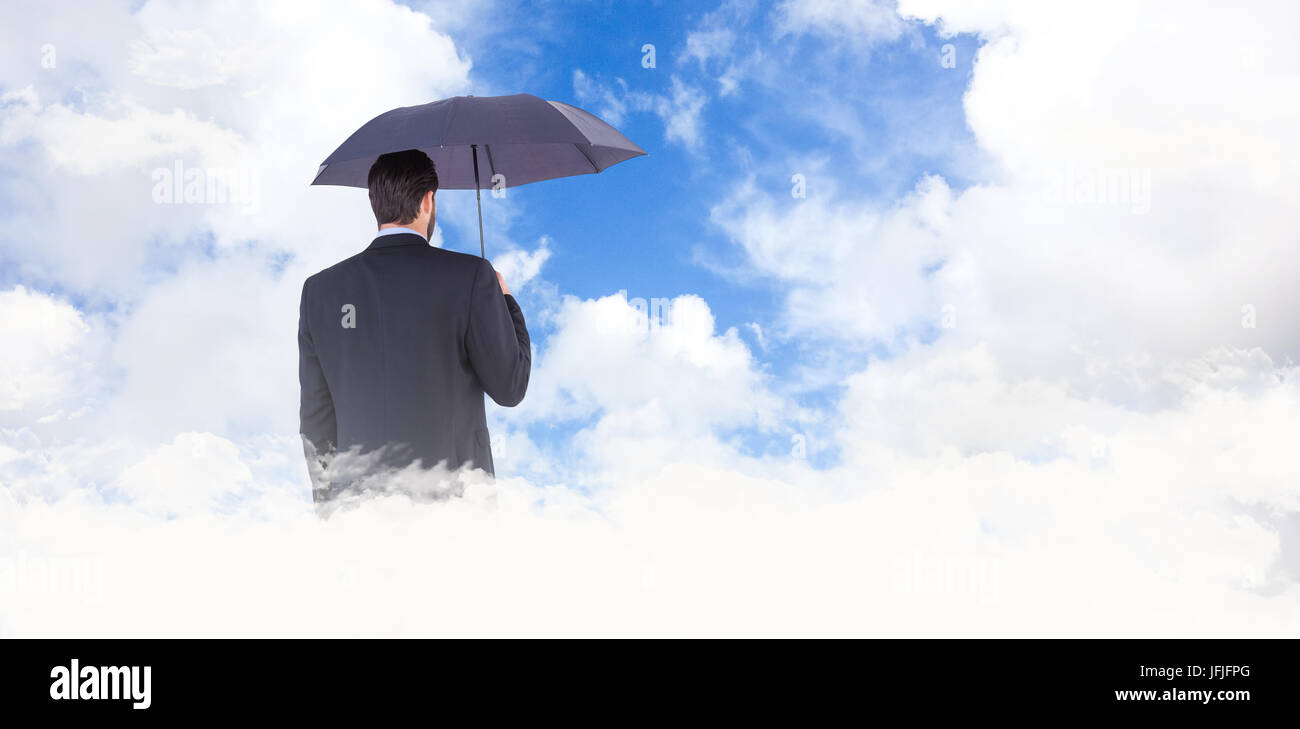 Composite image of businesswoman in suit holding umbrella Banque D'Images