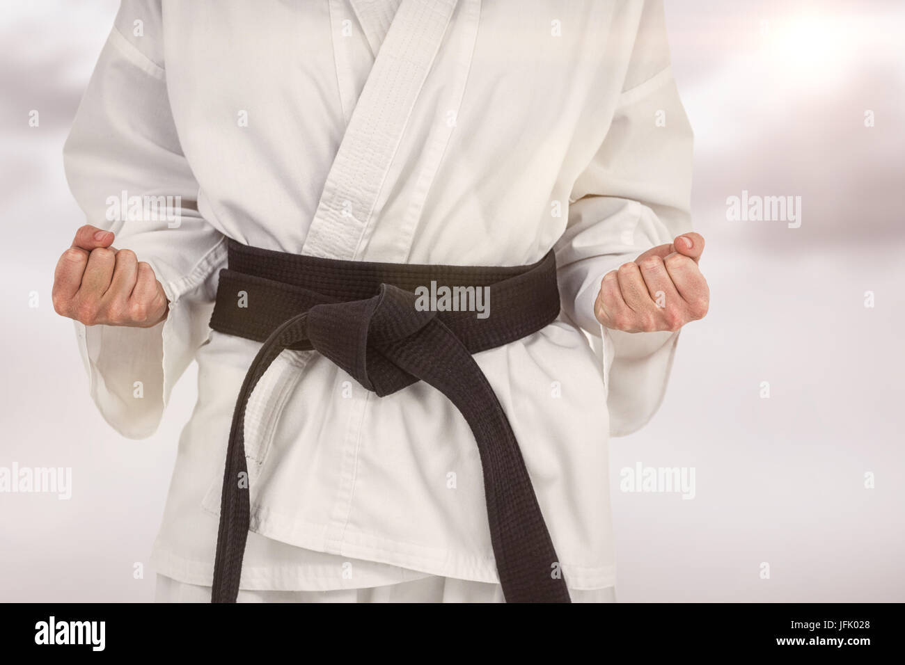 Image composite de l'athlète féminin posant en kimono Banque D'Images