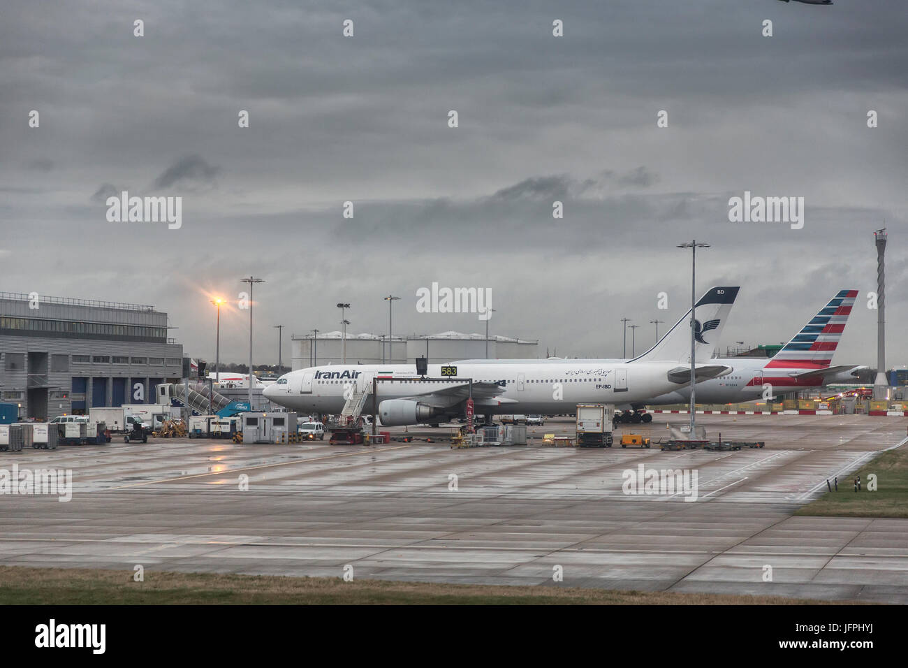 Iran Air sur le tarmac à l'aéroport de Heathrow à l'aube dans des conditions humides, Londres Banque D'Images