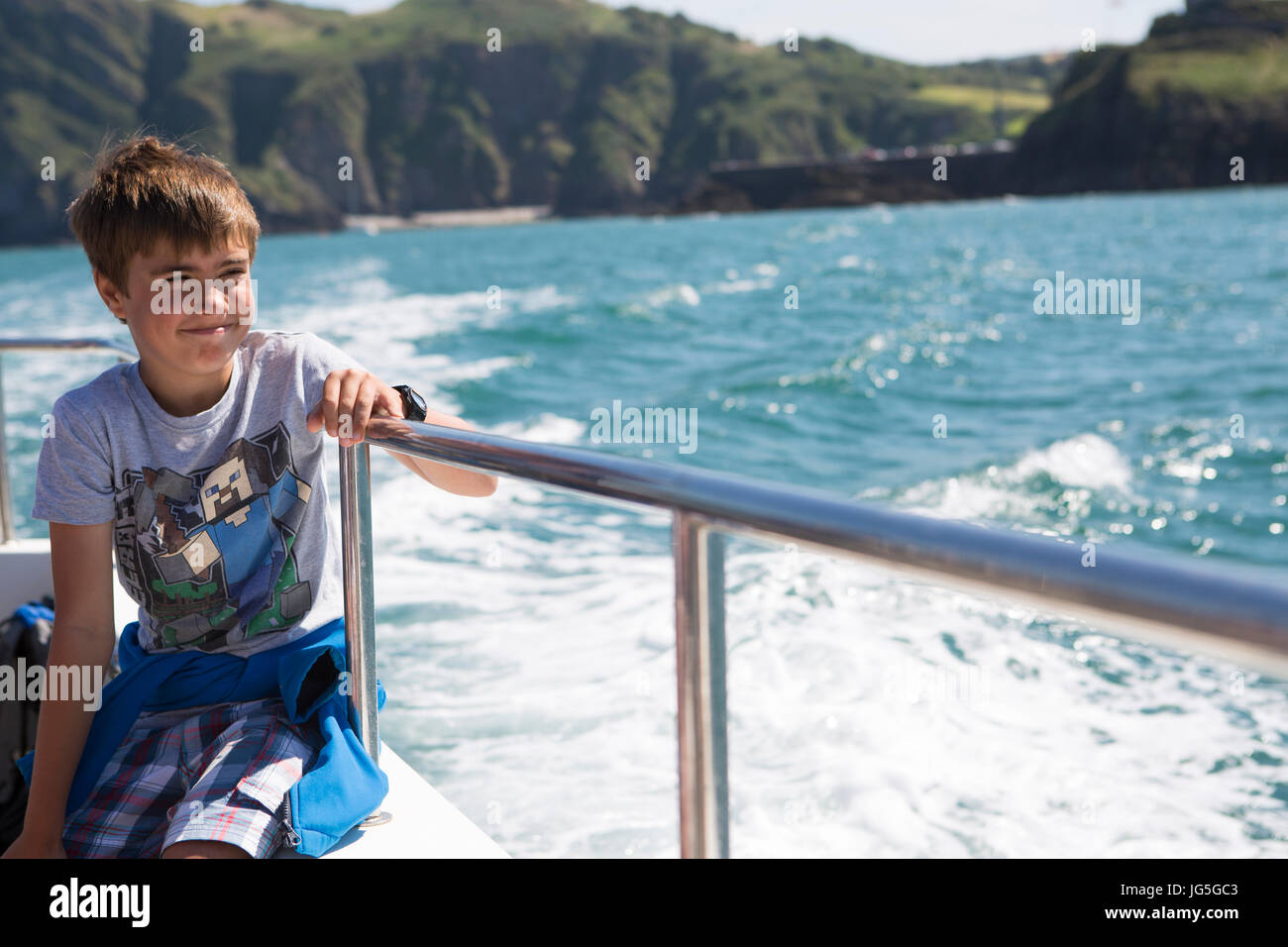 Un enfant sur un bateau à la mer, Devon UK Banque D'Images