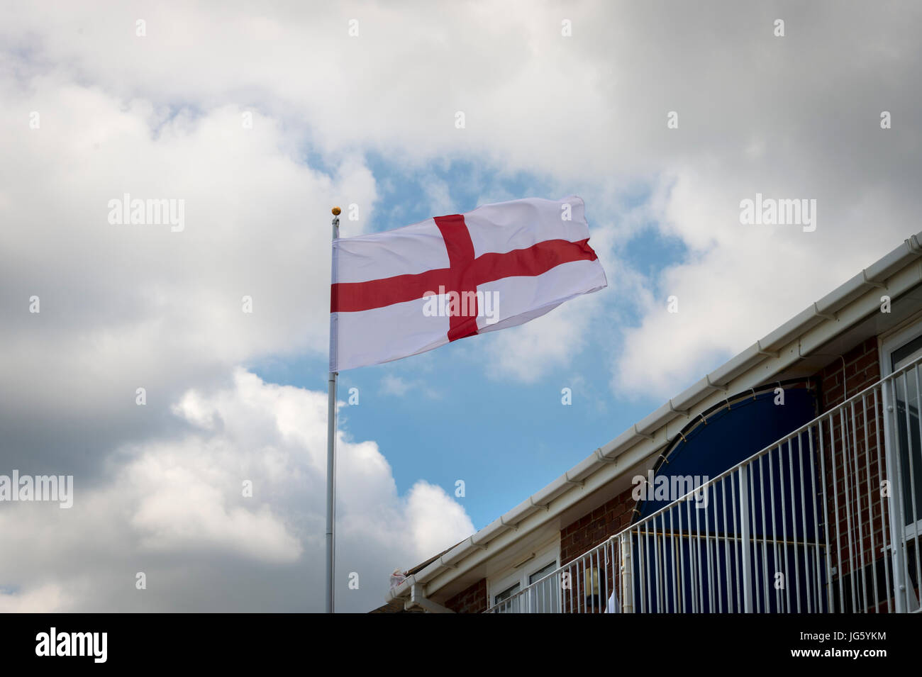 Drapeau de l'Angleterre sur un mât à l'extérieur d'une maison Banque D'Images