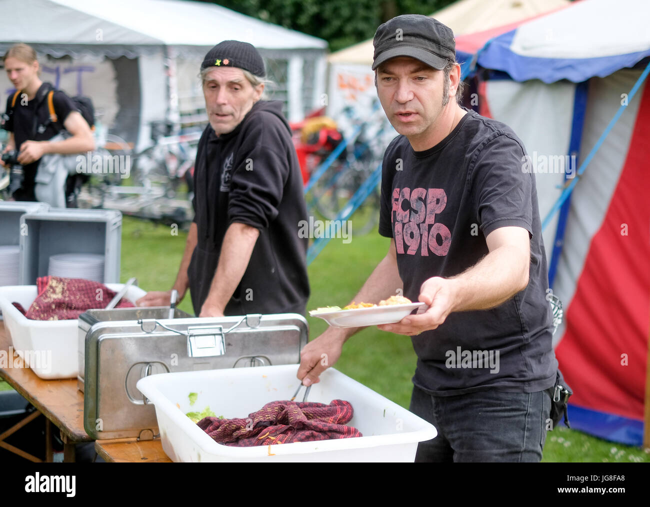 Hambourg, Allemagne. Le 04 juillet, 2017. Le TV-Plogstedt Ole chef donne de la nourriture aux participants du G20 au camp de protestation le Volkspark Altona à Hambourg, Allemagne, 04 juillet 2017. Photo : Axel Heimken/dpa/Alamy Live News Banque D'Images