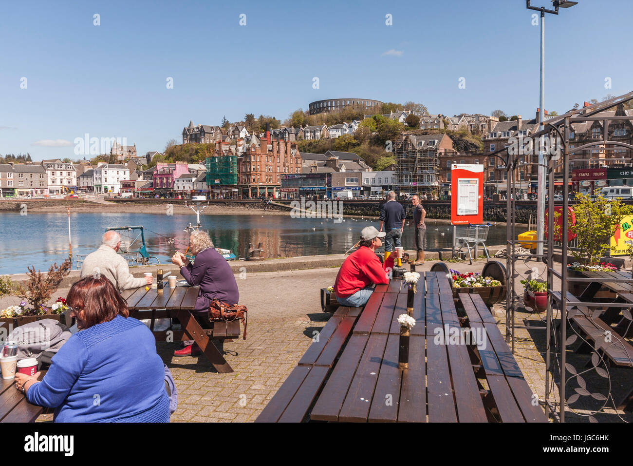 Les gens assis aux tables,avec des aliments et boissons à quai à Oban, Ecosse, Royaume-Uni Banque D'Images