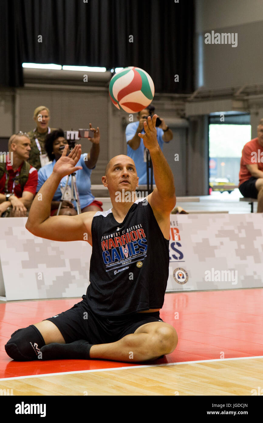 Le sergent de l'armée américaine. 1re classe Earl Ohlinger, de Savannah, Géorgie, sert la balle au cours d'une pratique pour la compétition de volley-ball assis pour le ministère de la Défense 2017 Warrior Jeux à Chicago, Illinois, le 30 juin 2017. La DOD Warrior Jeux sont un événement annuel permettant aux blessés, malades et blessés militaires et anciens combattants au style paralympiques sports comme le tir à l'arc, randonnée à vélo, terrain, tir, le volleyball assis, natation, athlétisme et de basket-ball en fauteuil roulant. (U.S. Photo de l'armée par la FPC. Genèse Gomez) Banque D'Images