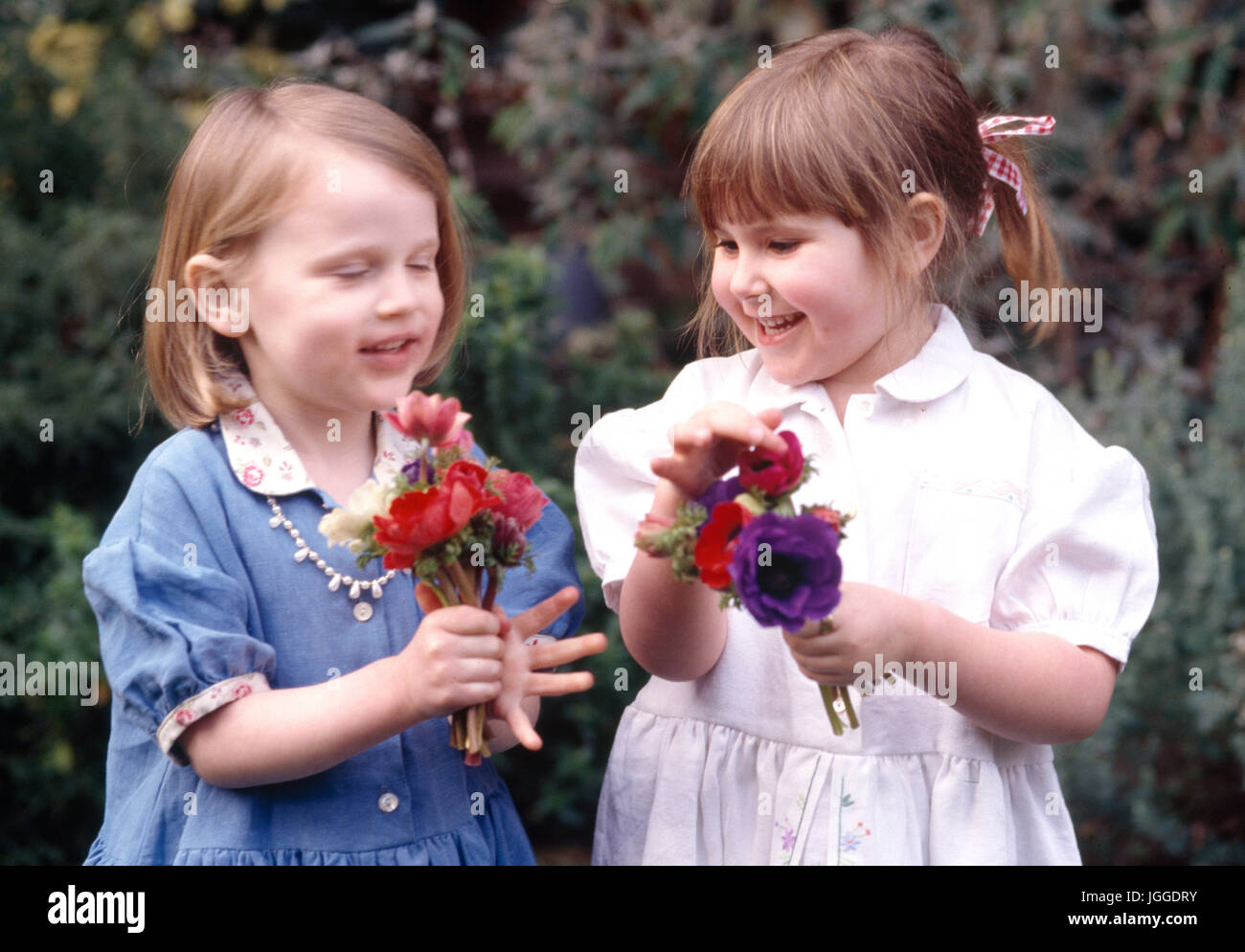 Les petites filles en comparant leurs bouquets de mariage Banque D'Images