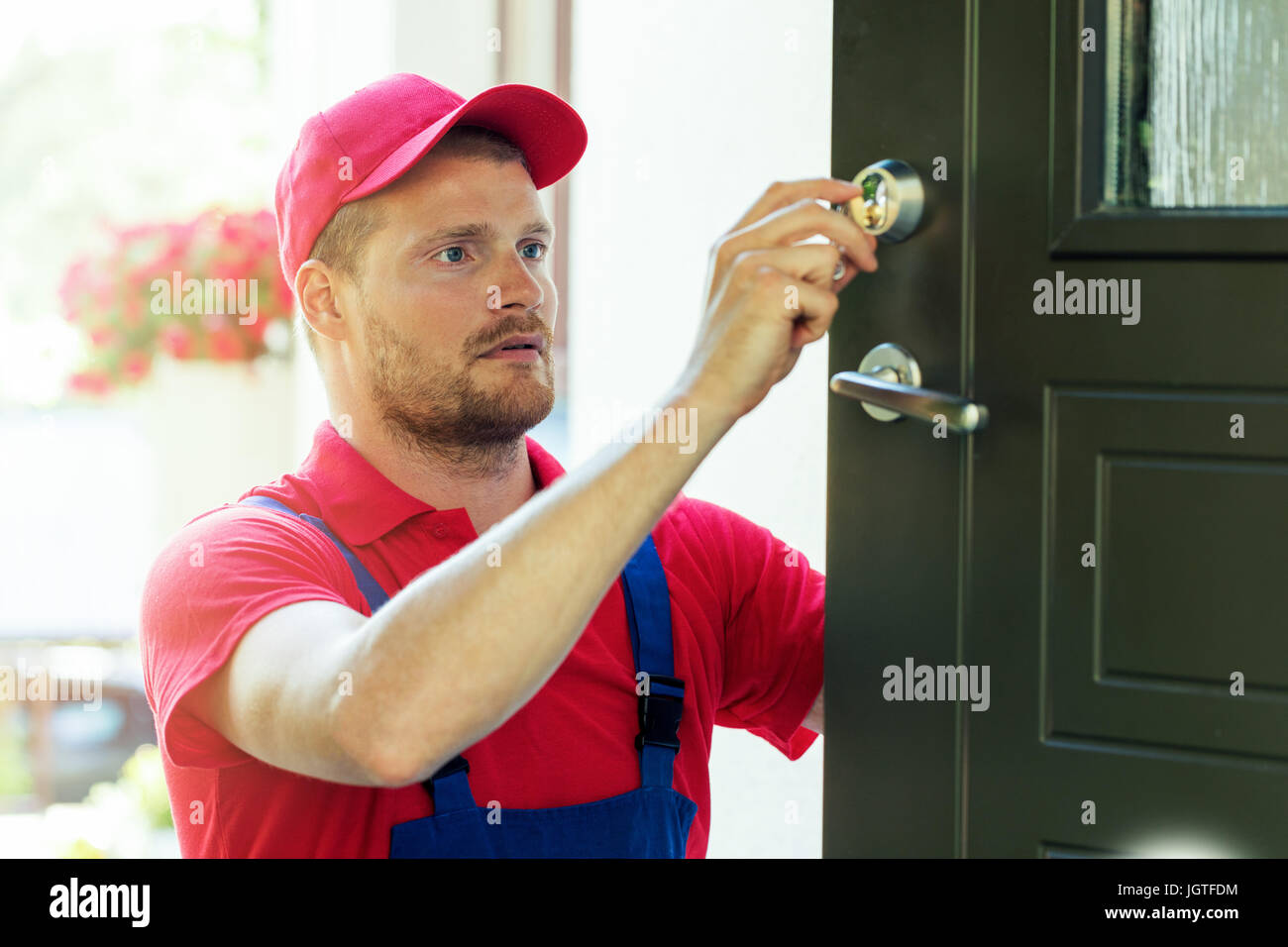 Handyman fixing serrure de porte de la chambre Banque D'Images