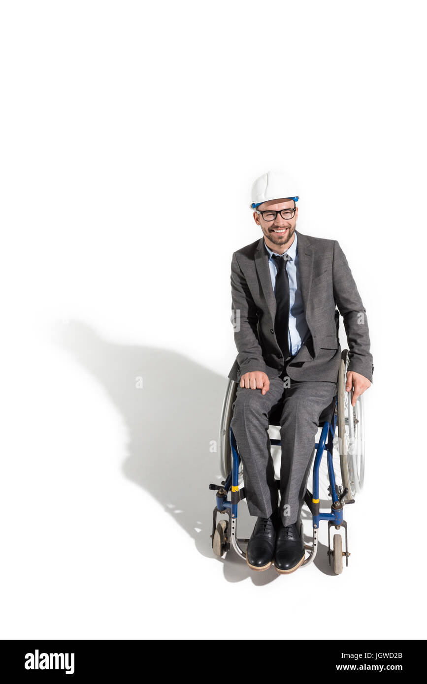Mobilité smiling architect sitting in wheelchair isolated on white Banque D'Images