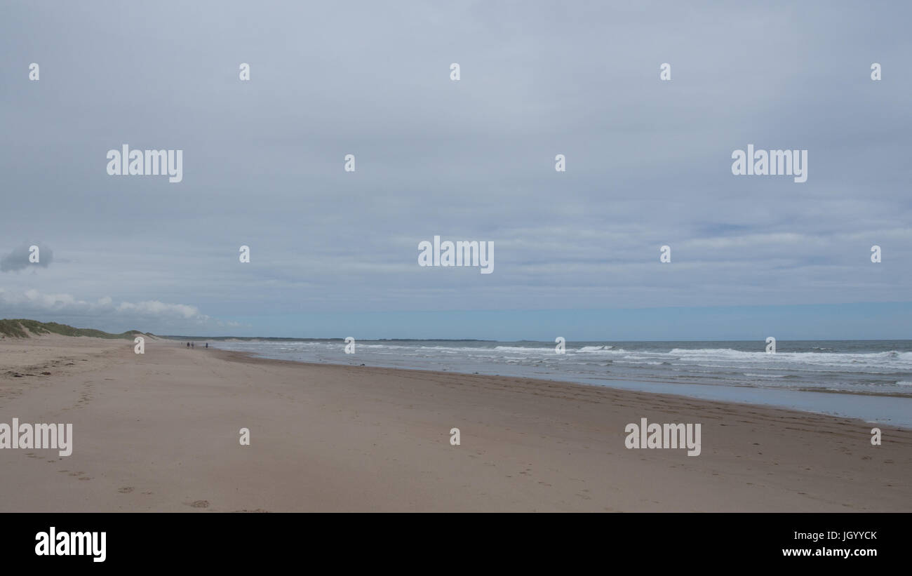 Druridge Bay, Northumberland, une plage balayée par des randonneurs dans la distance Banque D'Images