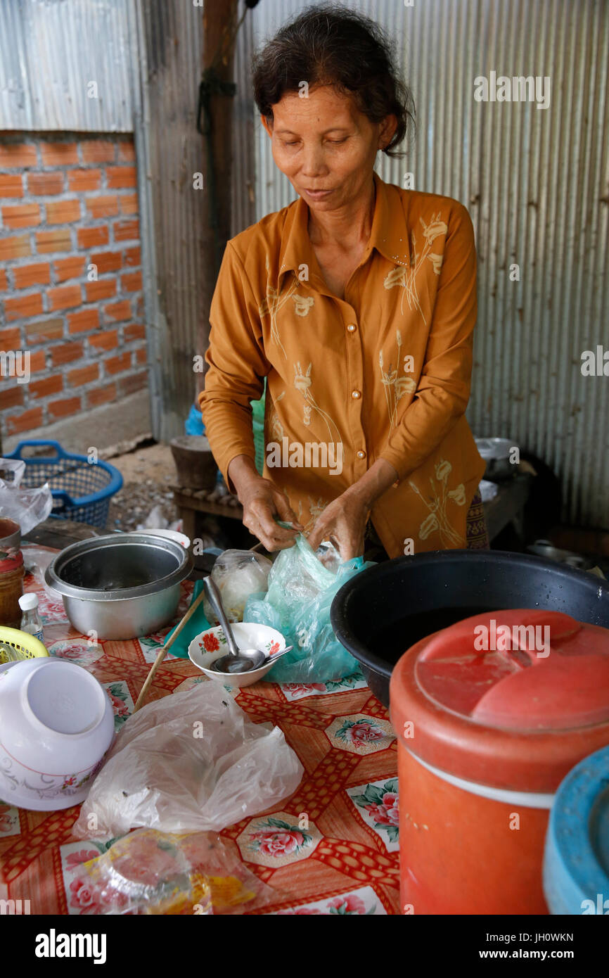 Client de la microfinance Chamroeun Kean Ya dans son épicerie et restauration d'entreprise. Le Cambodge. Banque D'Images