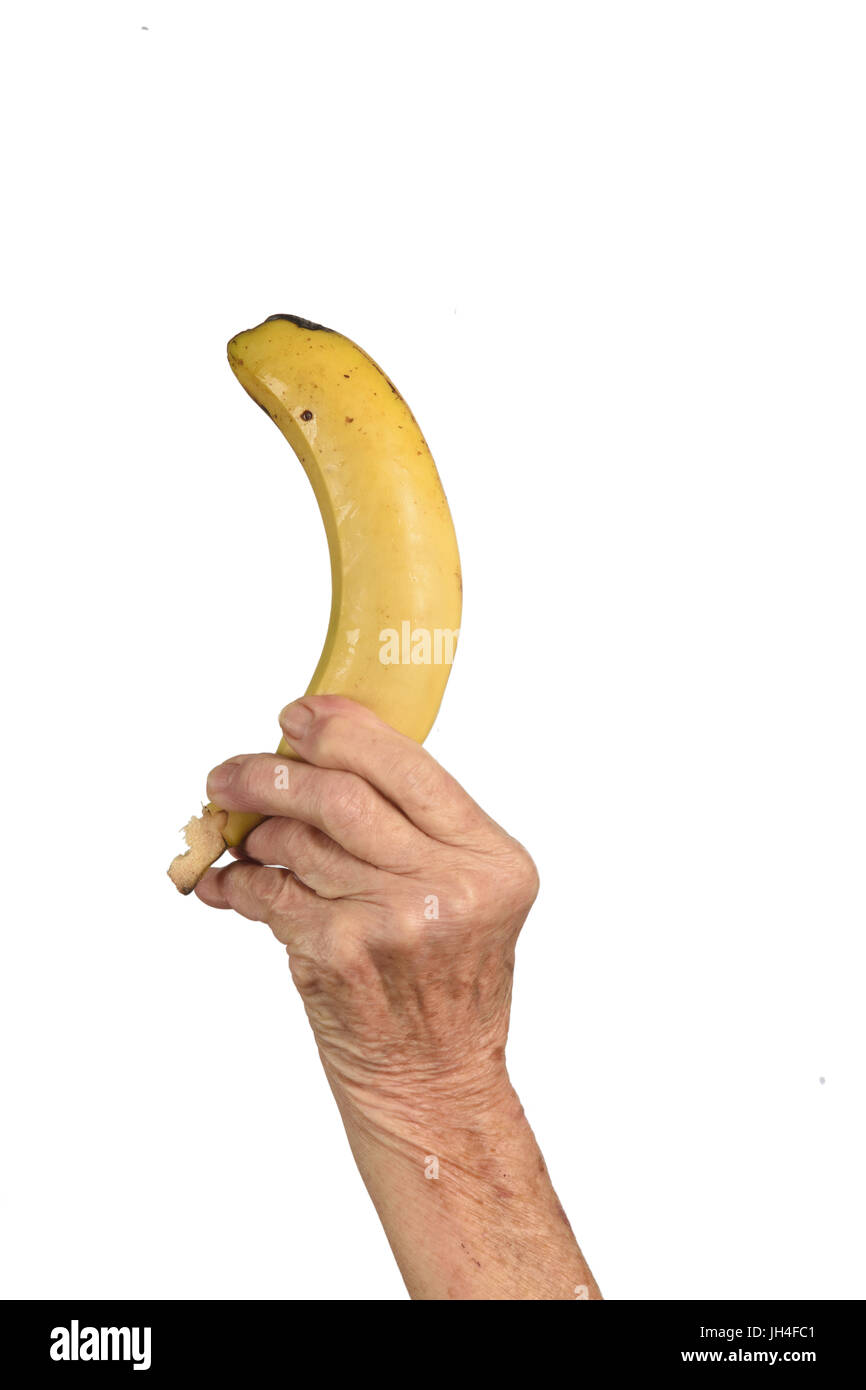 Hand of senior woman et banane isolated on white Banque D'Images