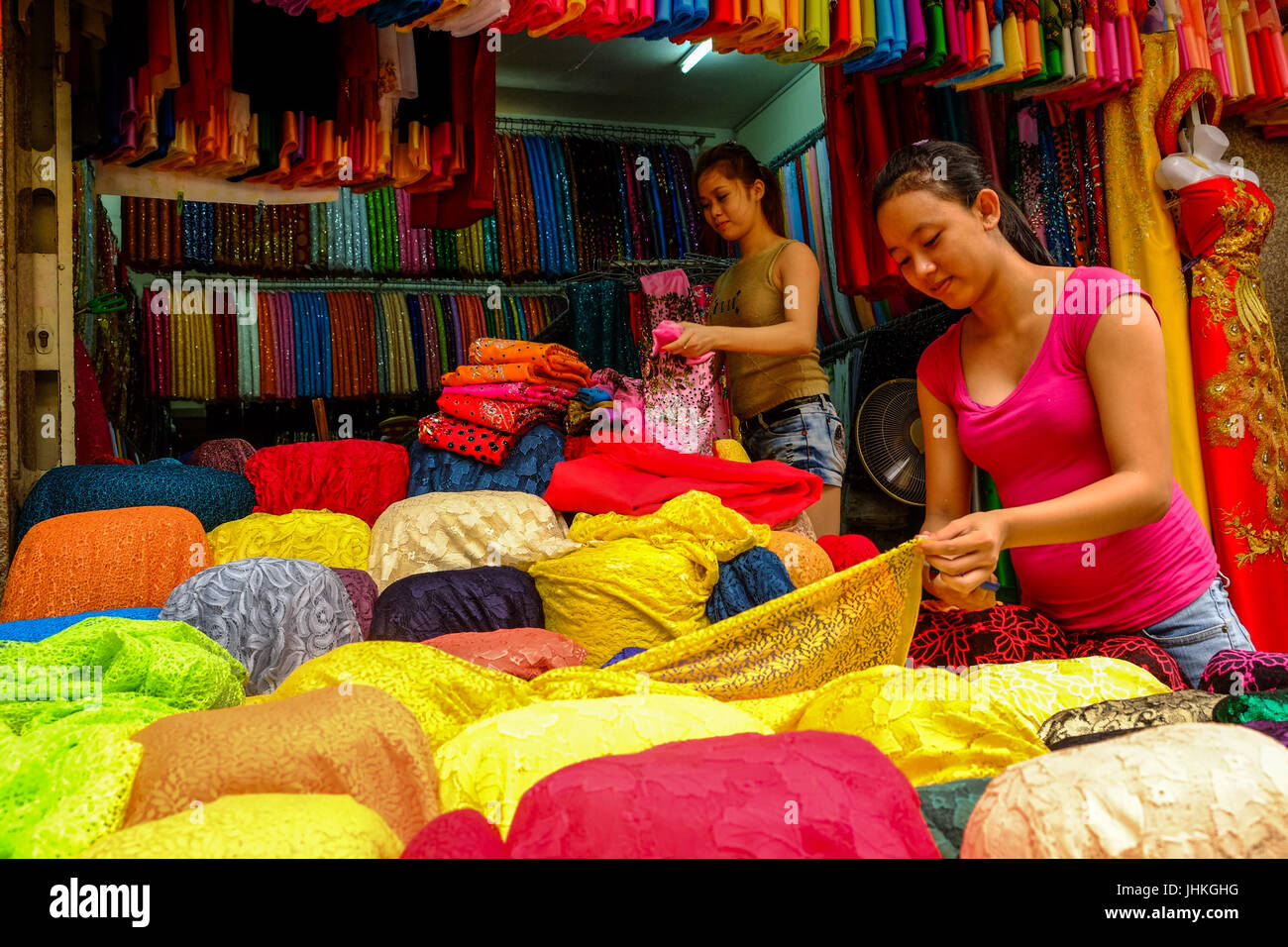 Les travailleurs du textile trier tissus à leur stand à Cho Lon, Ho Chi Minh City, Vietnam Banque D'Images