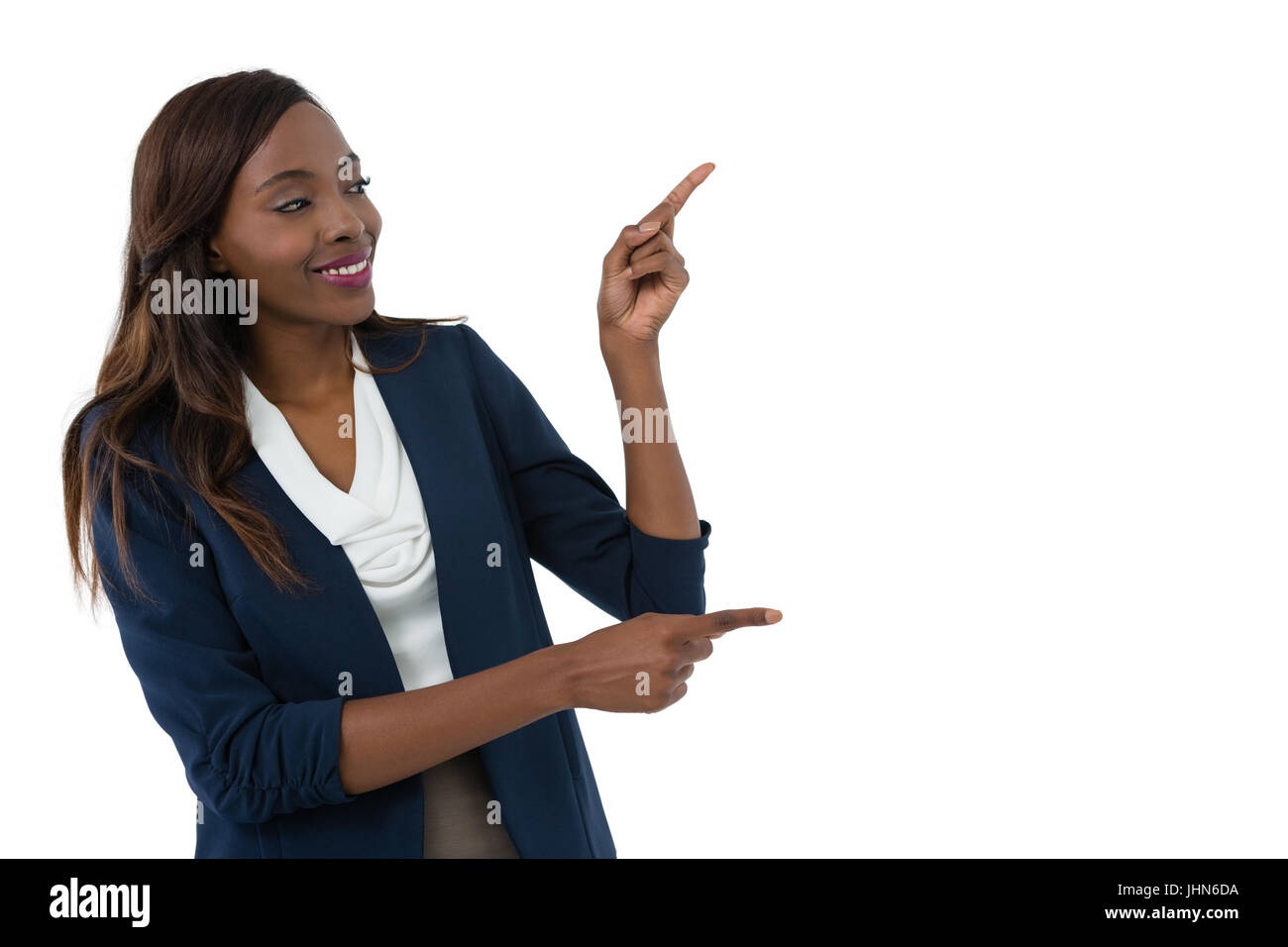 Smiling businesswoman gesturing during presentation against white background Banque D'Images