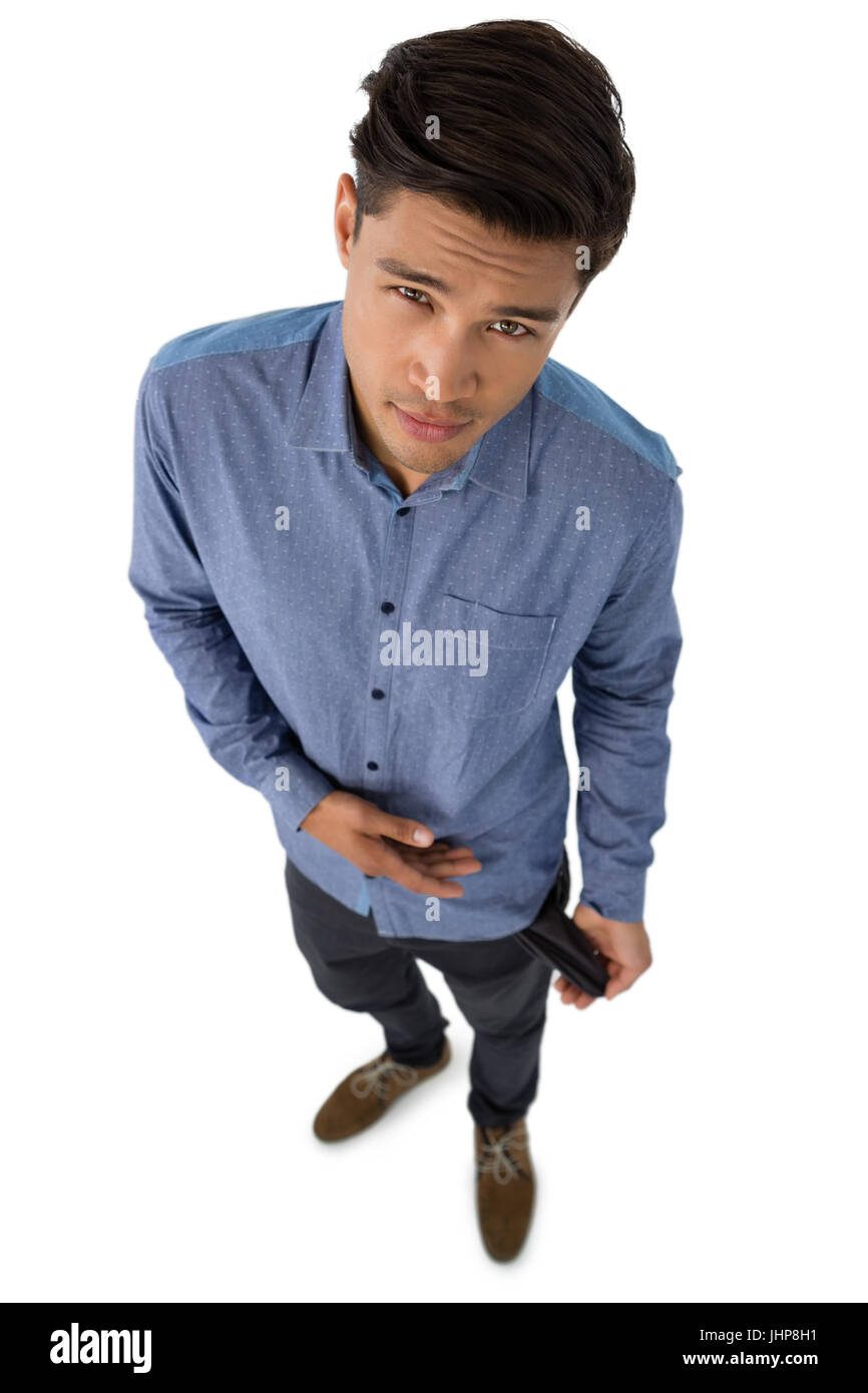 High angle portrait of businessman showing vide poche pendant que standing against white background Banque D'Images