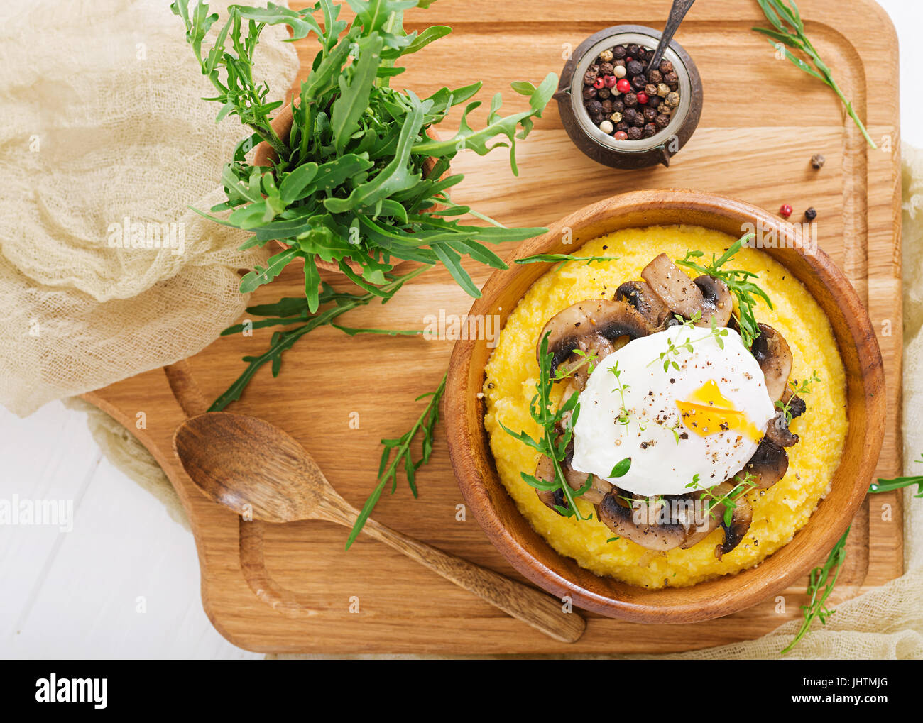 Le petit-déjeuner. La polenta aux champignons et œuf poché. Mise à plat. Vue d'en haut. Banque D'Images