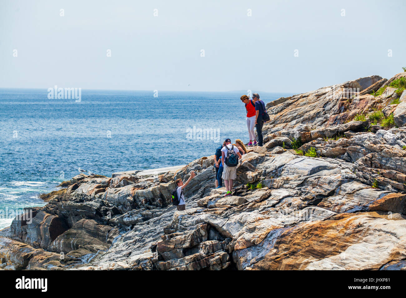 Une famille explore la côte rocheuse à Bristol, Maine, USA. Banque D'Images